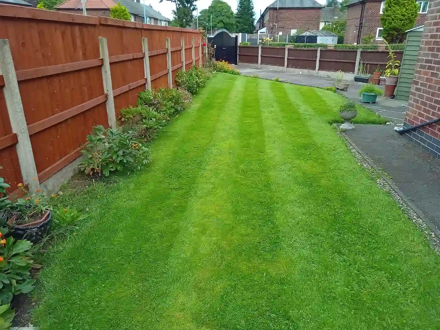 A striped, freshly-renovated lawn maintained by M.R. Garden Services in South Manchester